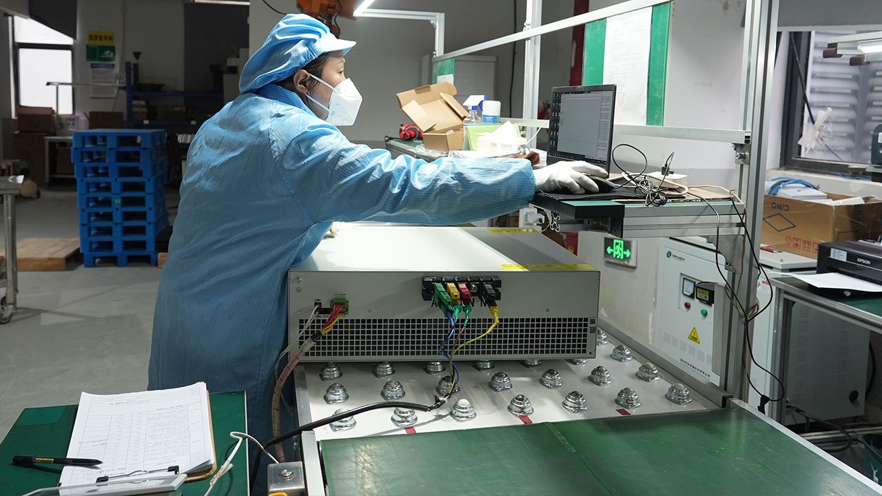 Ikonmac technician performing final inspection on power quality equipment before shipment