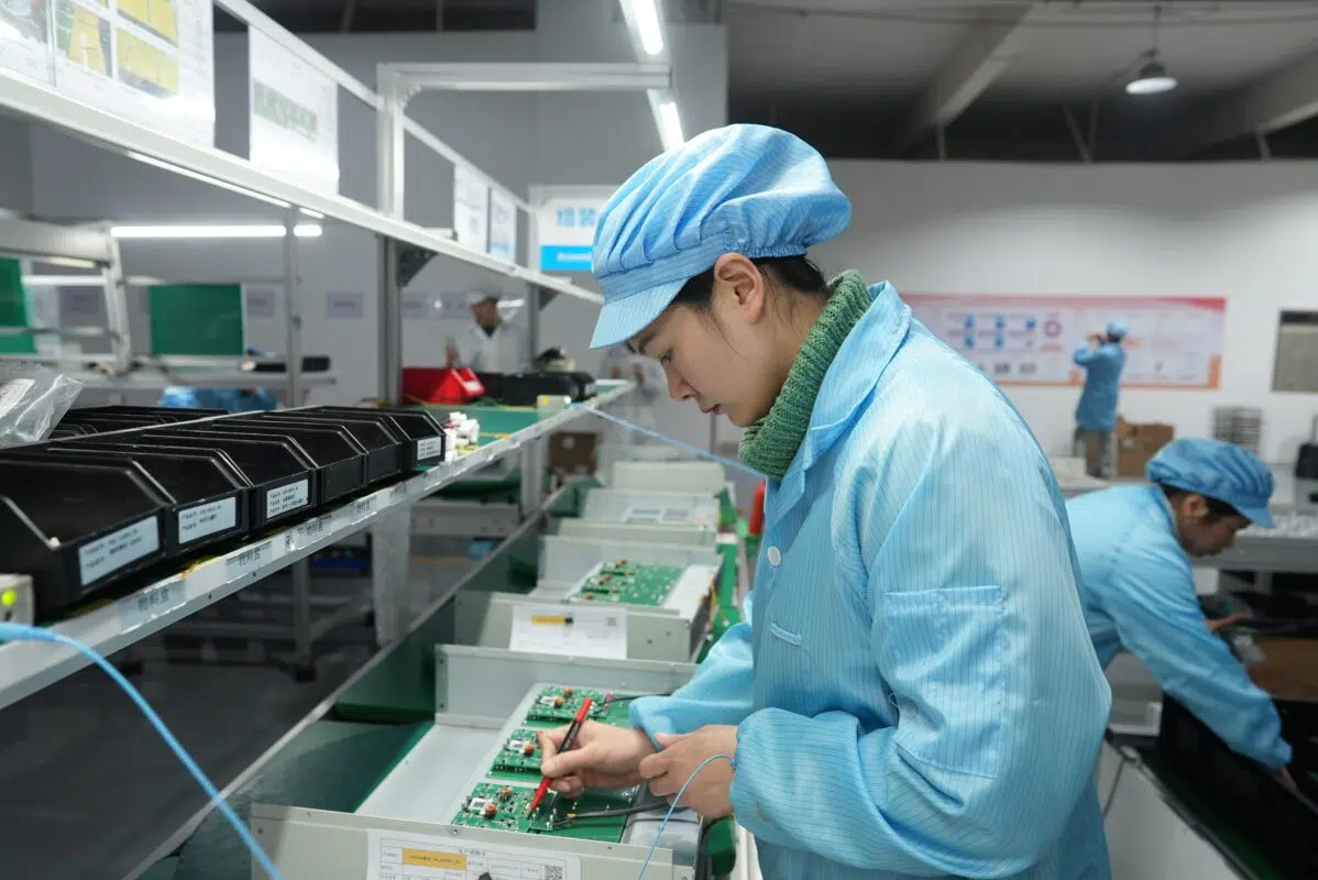 Ikonmac technician performing electrical testing on PCB units during power electronics assembly