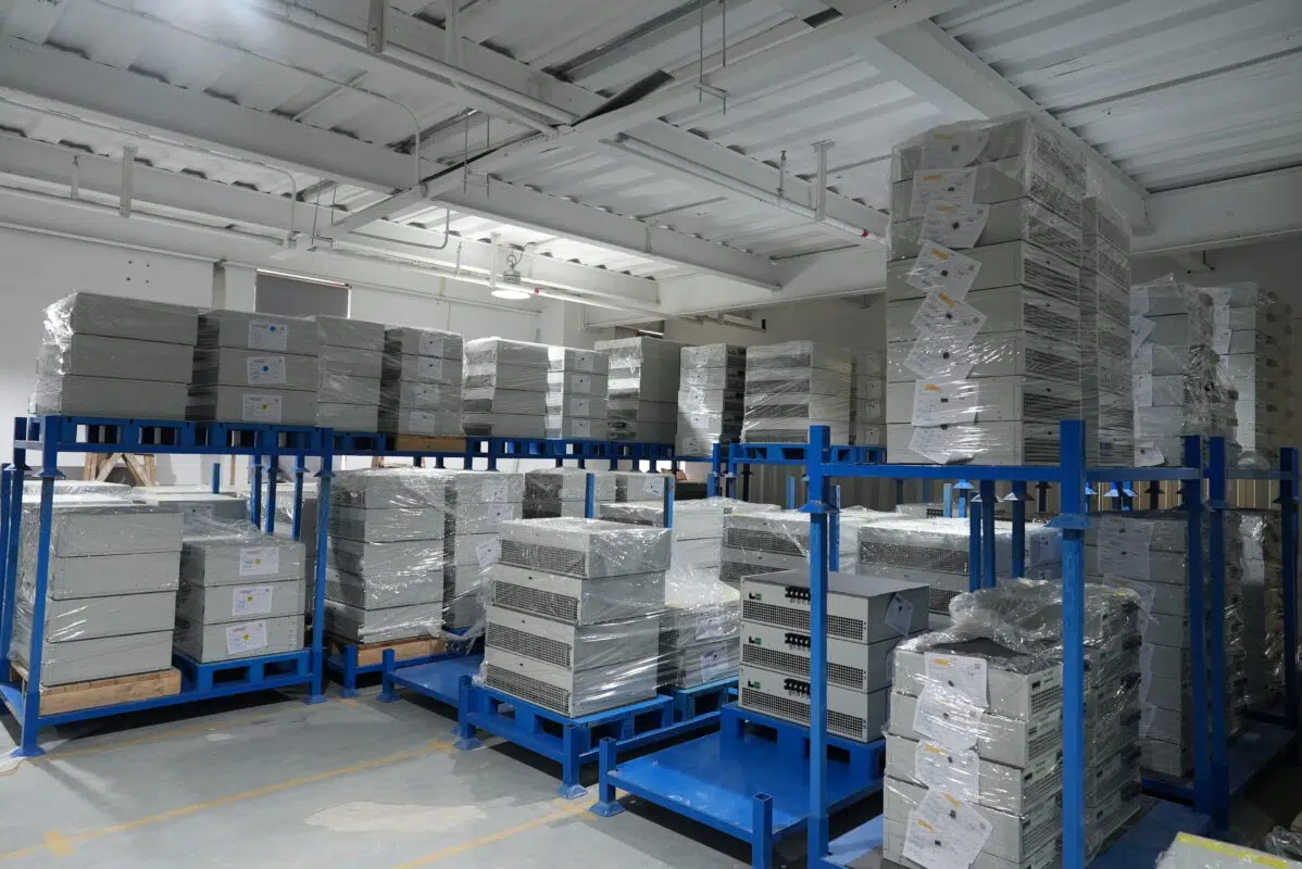 Ikonmac warehouse with stacked Active Harmonic Filter (AHF) and Static Var Generator (SVG) modules ready for shipment